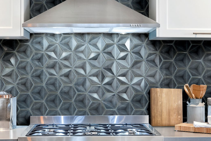 Hexagonal 3D tile in a kitchen behind a stove.