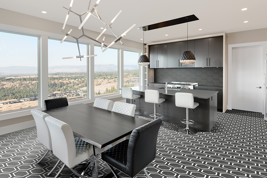 A modern kitchen space with grey hexagon tile on the backsplash, and grey and white tile on the floor.