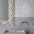 A grey-blue tile design on a bathroom wall.